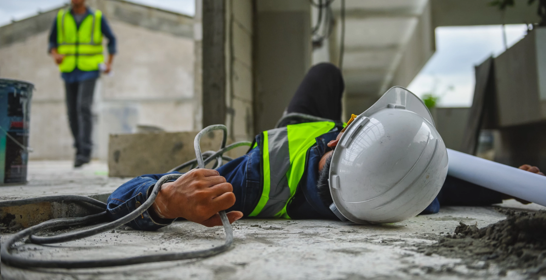 man on the ground holding a wire