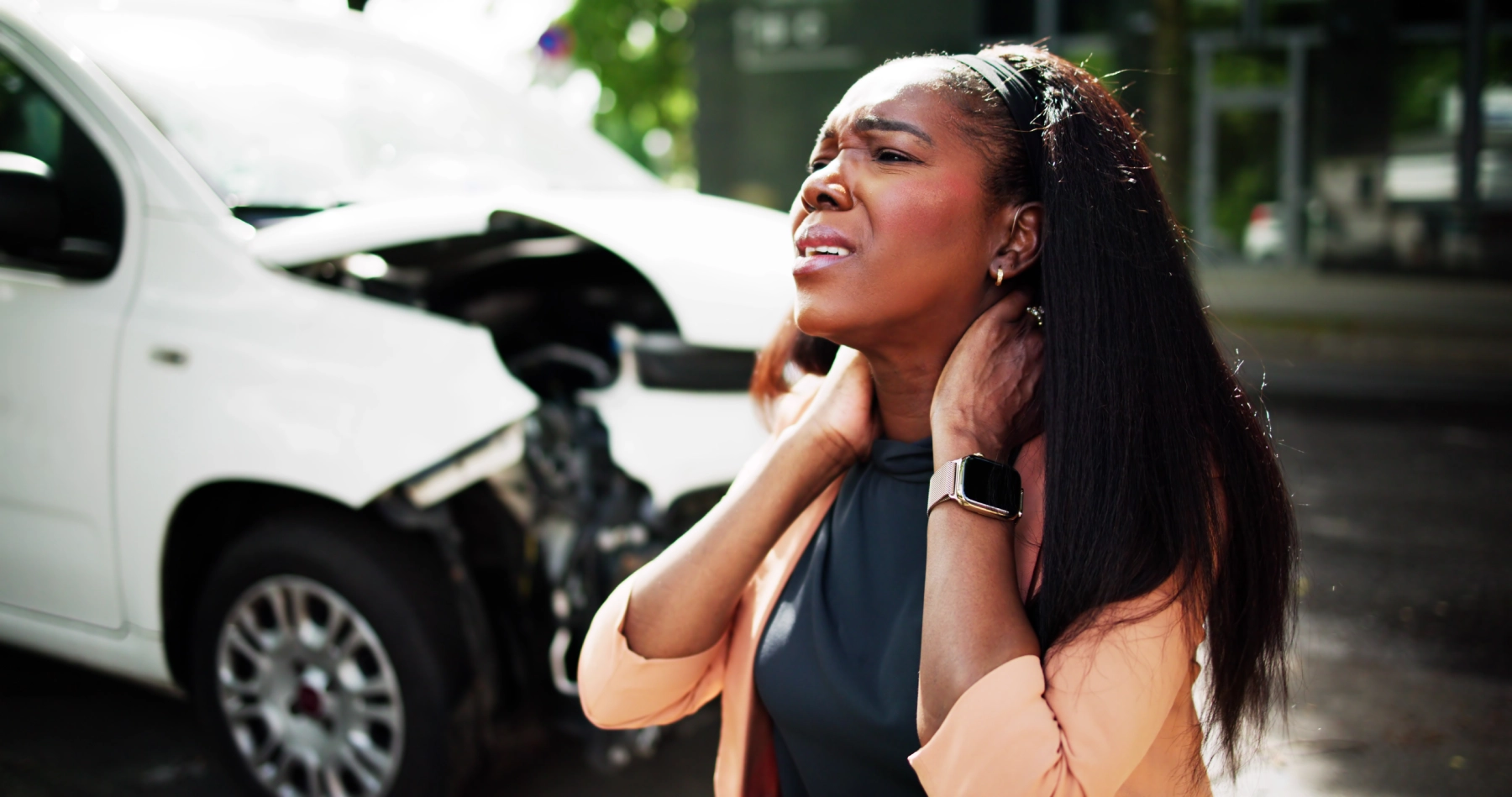woman holding neck after car crash