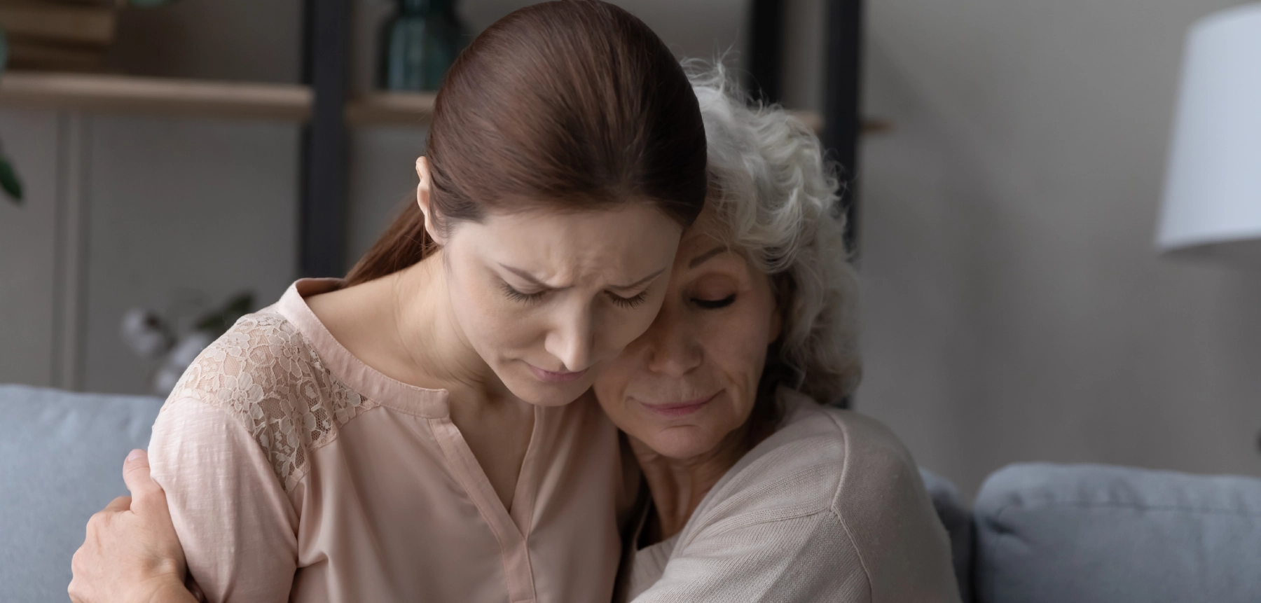 2 sad women hugging due to wrongful death